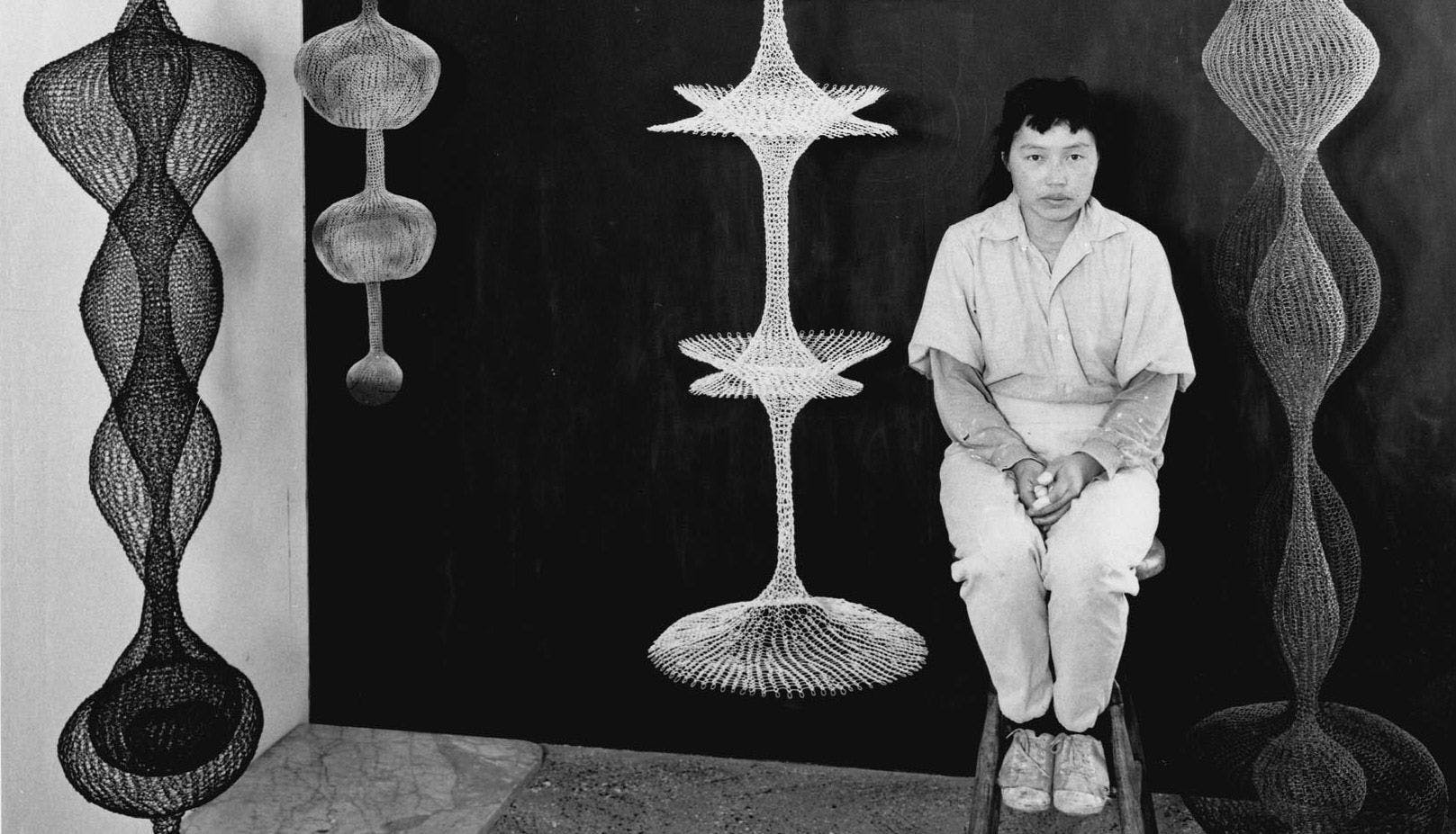 A photo of Ruth Asawa in her studio, dated 1956. Photo by Paul Hassel.